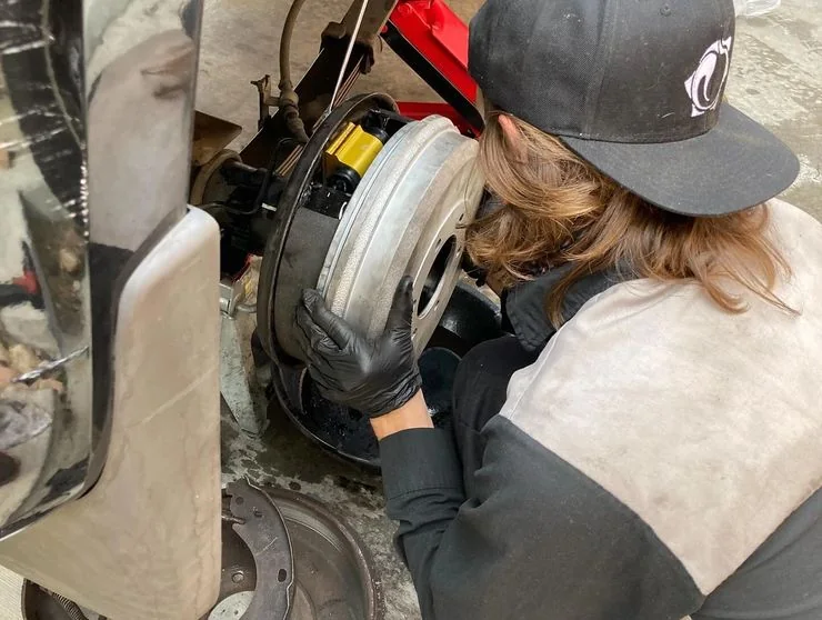 Christian, owner of Lemon Aid Mobile Mechanic, working on a vehicle